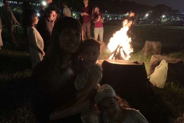 racheli with baby and fire